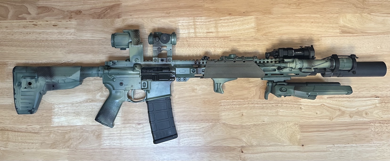 Rifle laid out on wood floor